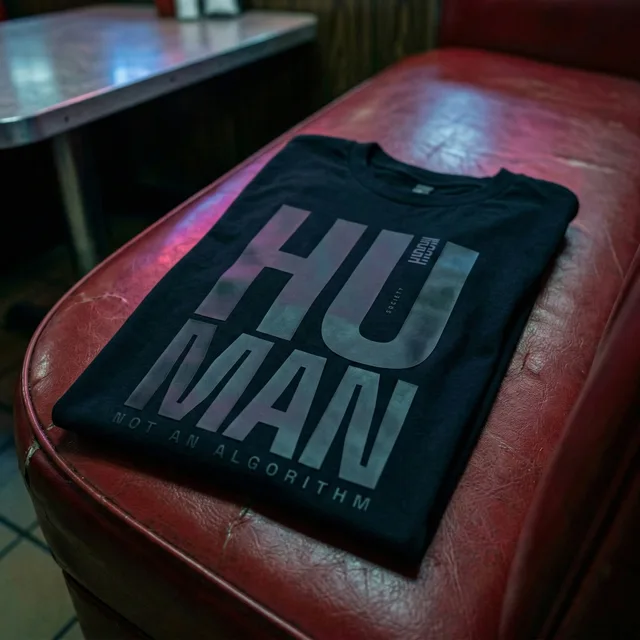 Folded Human T-shirt catching the subdued colours of a red diner seat