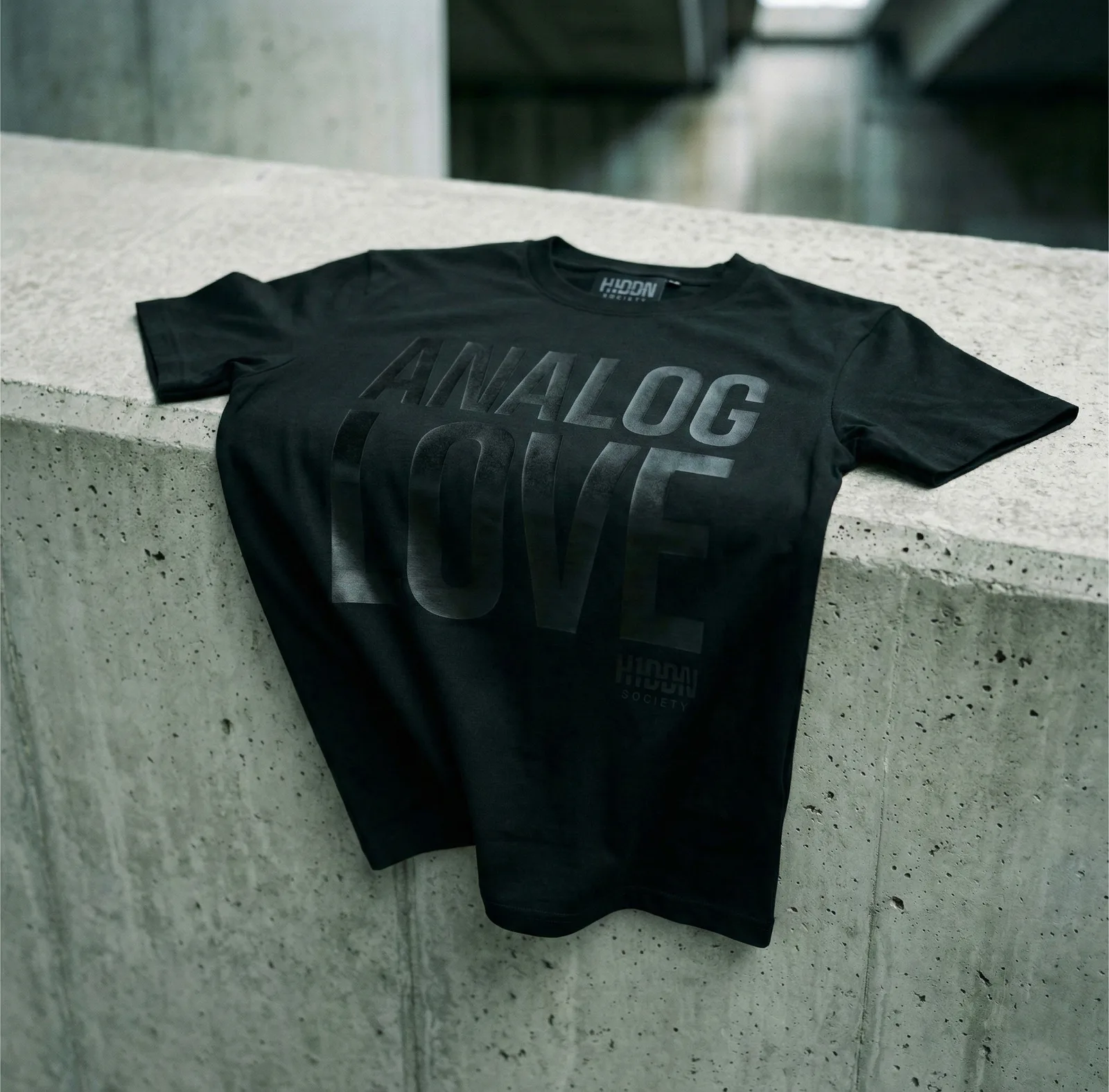 Black H1DDN shirt on concrete