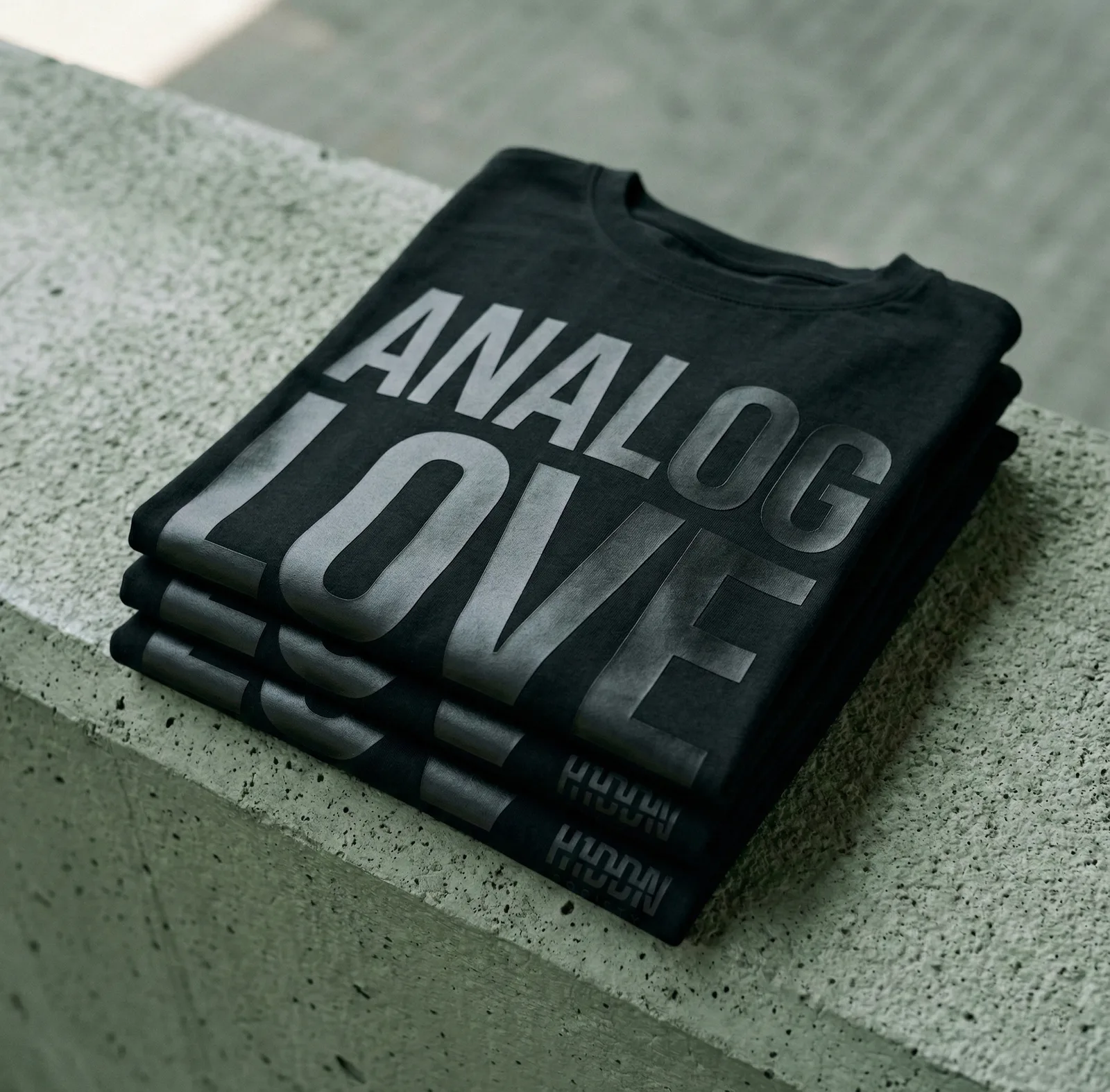 Stacked black H1DDN shirts